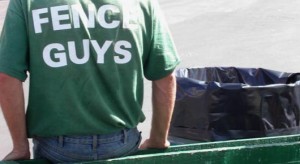 person, garbage can and fence